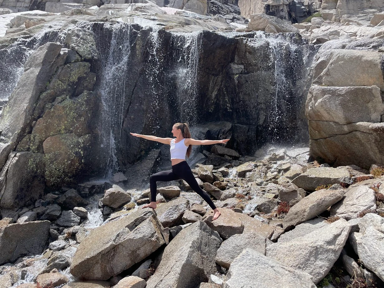 Warrior pose near a waterfall